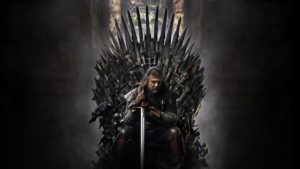 Ned Stark sitting on the iron throne.
